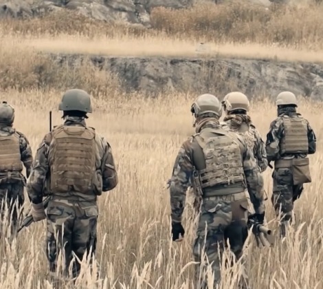 Group of soldiers walking in a field 